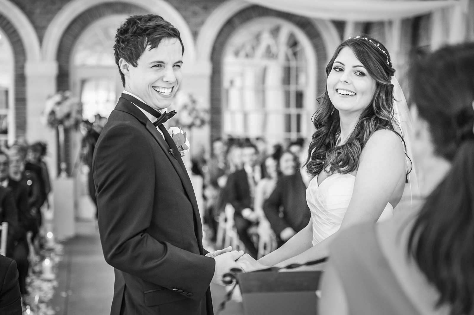 The beaming couple during the wedding ceremony at Great Fosters Hotel